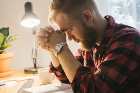 a bearded man praying